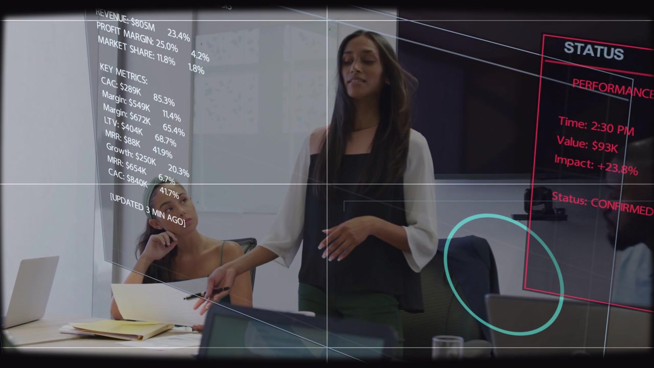 Standing presenter initiating overlay while explaining metrics for business update and passing pen