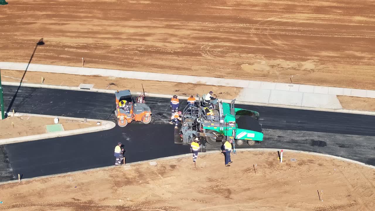 Road Construction with Asphalt Paver and Road Roller