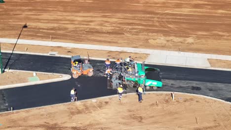 road construction with asphalt paver and road roller