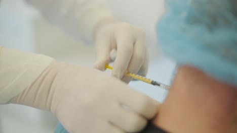 a doctor administering botulinum injections to a patient as a treatment for bruxism and spasticity. the clinical setting emphasizes professionalism and medical expertise