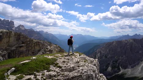 hiker woman standing up achieving the top dolomites alps.