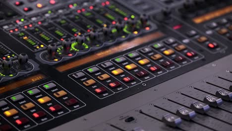 faders and lights moving on the sound board in vegas mode during a music festival in canada - closeup shot