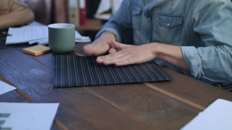 male hands pounding on folder and working with office documents at office table