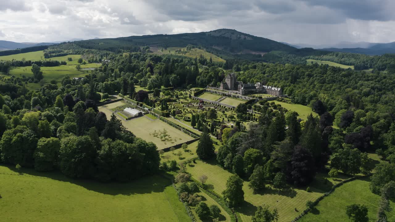 Wide drone shot of Drummond Castle Gardens in Scotland's beautiful green countryside