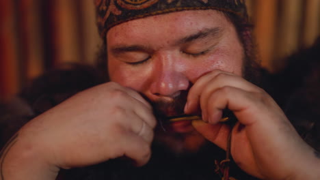 meditating man in altai clothes plays vargan at ritual