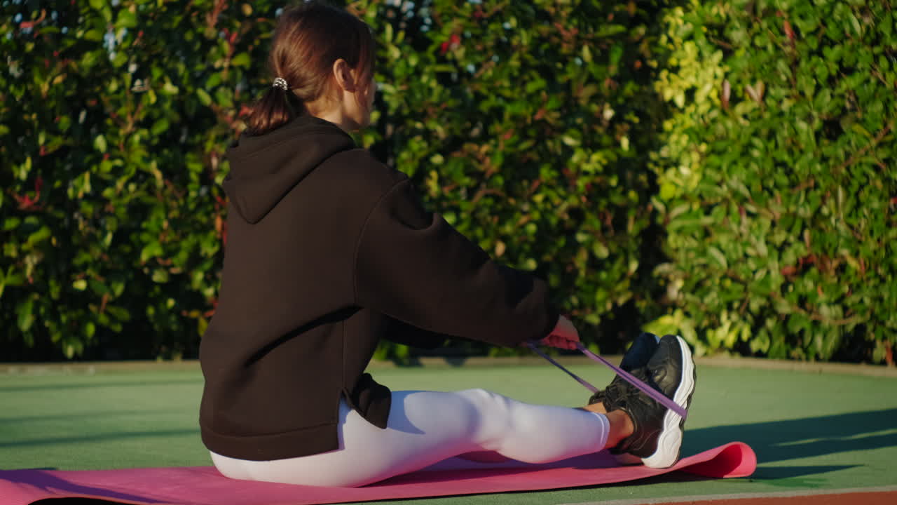 Woman Stretching with Resistance Band Outdoor