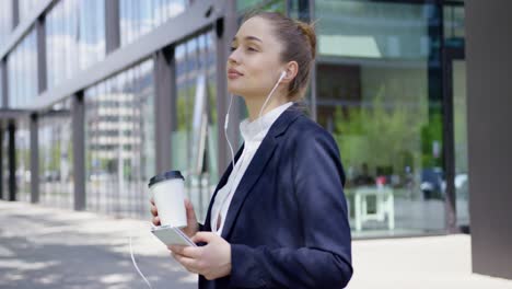 woman in formal with smartphone and coffee