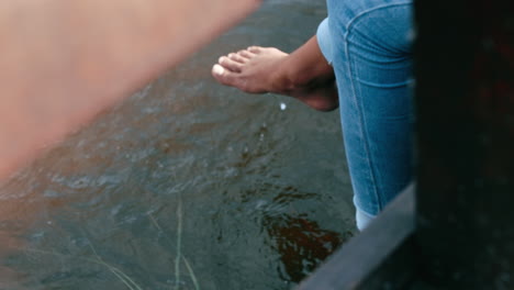 closeup of a barefoot person dipping their feet