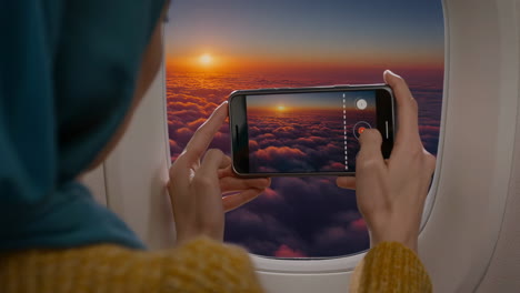 taking pictures of the sunset from an airplane window