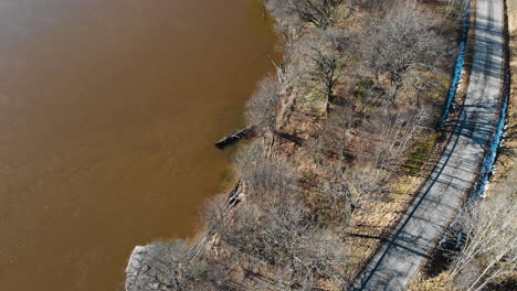 top down drone aerial view of lake with brown water