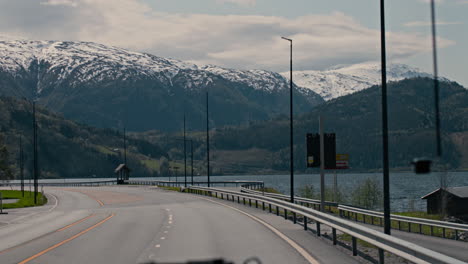 hand-held dolly shot towards snow-capped mountains in the vestland region