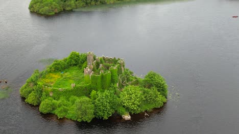 a zoomed aerial view of mcdermott's castle on lough key