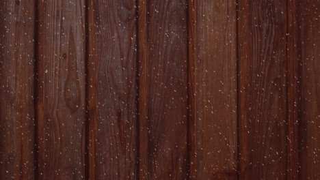 animación de un paisaje de invierno con nieve cayendo sobre tablas de madera