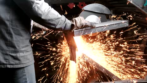 cutting of metal. closeup men cut metal with a circular saw. sparks fly to the side.