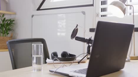 empty room at home with laptop and video equipment on table, slow motion