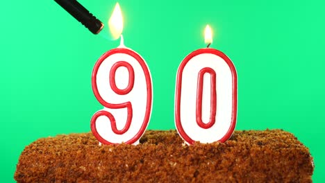 cake with the number 90 lighted candle. chroma key. green screen. isolated