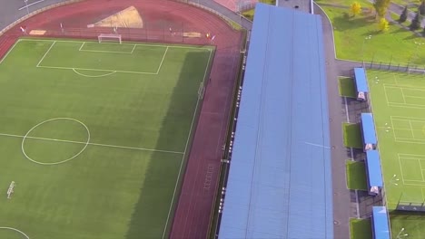 aerial view of sports complex with football and track field