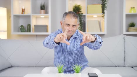 Man-making-heart-symbol-for-camera.