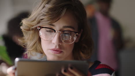 close up young caucasian woman using digital tablet computer in cafe student enjoying watching online entertainment reading social media on portable device wearing glasses