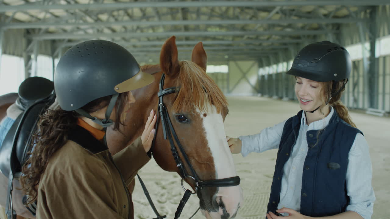 Two Female Riders Caressing Lovely Horse