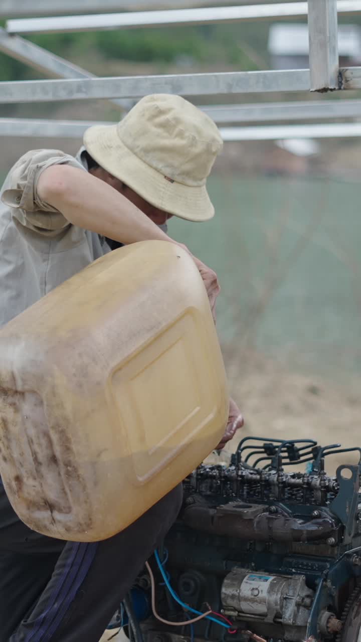 A man fills an engine with fuel