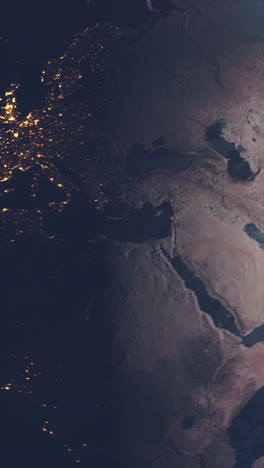 vertical video view from space of asia and europe continents with city lights visible as earth rotates transitioning from day to night. science space footage idea for adding to social media videos.