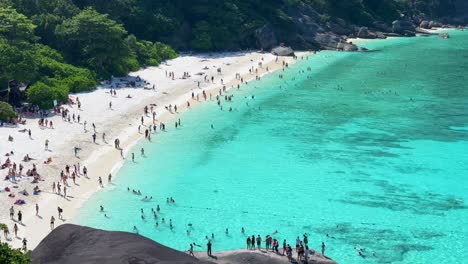 crowded beach with tourists during peak season at similan island in phuket, thailand