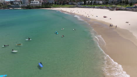 Fly-Over-Tourists-On-The-Famous-Bondi-Beach-In-Sydney,-New-South-Wales,-Australia