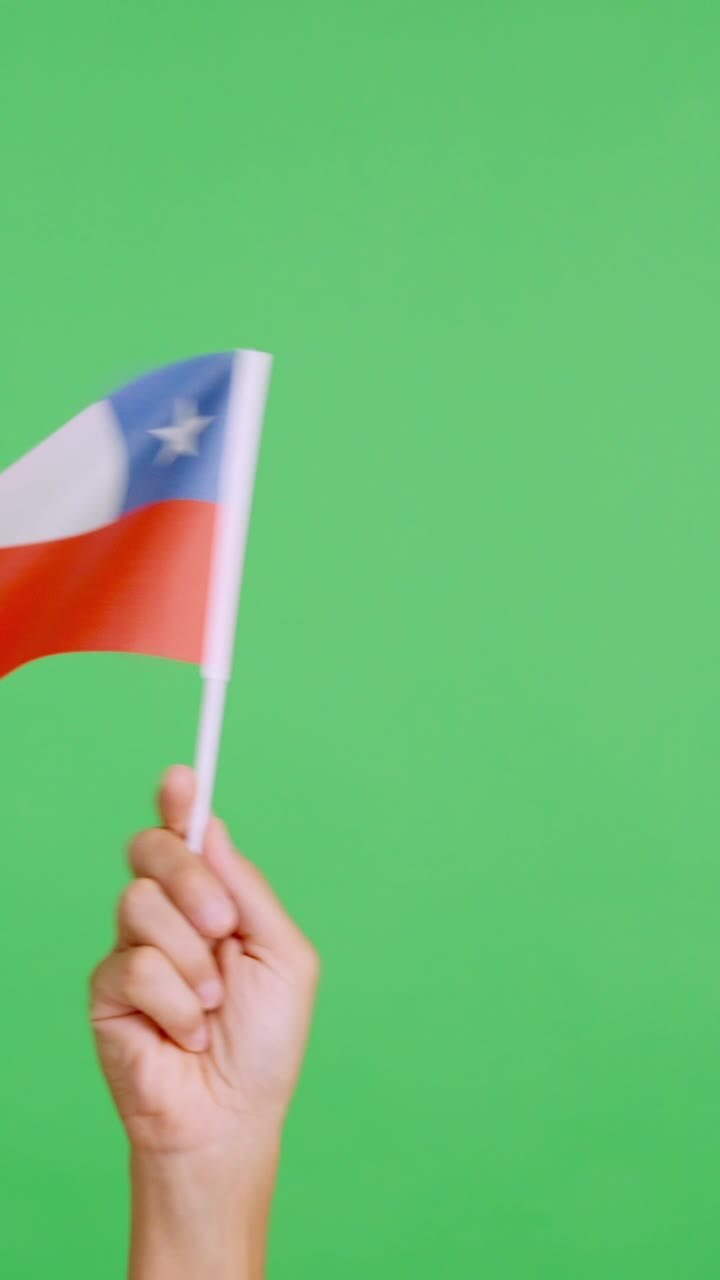 Hand waving a pennant of a chilean national flag