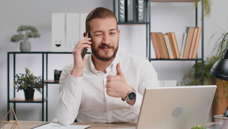 young business man showing smartphone asking to make telephone conversation gesturing call me sign
