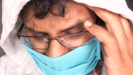 close-up of a person wearing a mask and glasses