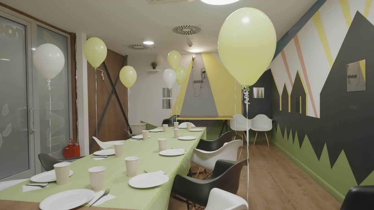 Empty Party Room Set Up with Balloons and Tableware
