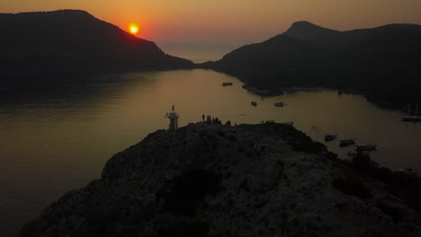 tourist group gathers atop st nicholas mountain summit to watch sunset