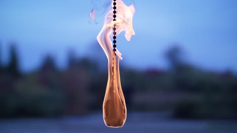 single fire poi close up dangling center frame in slow motion