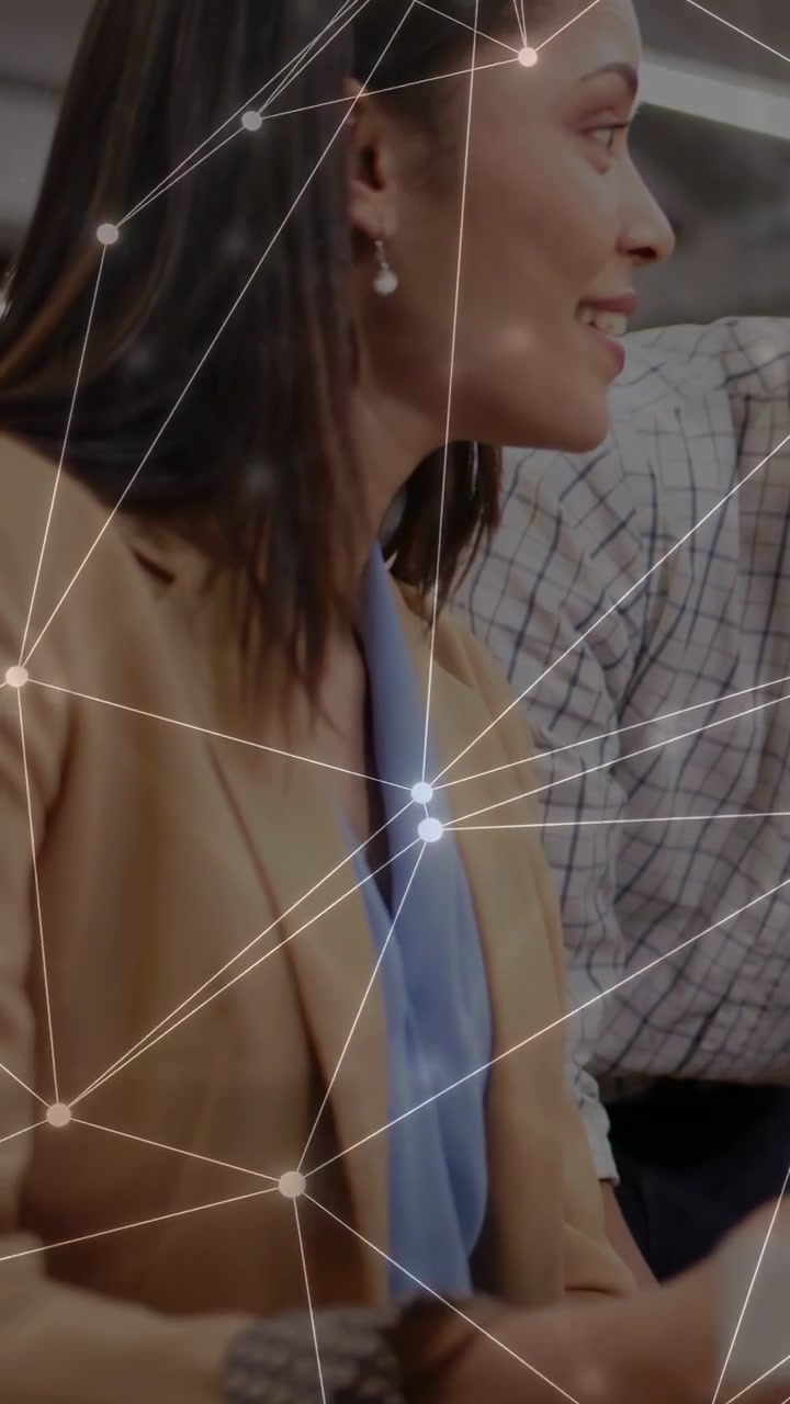 Vertical video: Woman hearing peer quip at work, turning, gesturing, laughing with net overlay