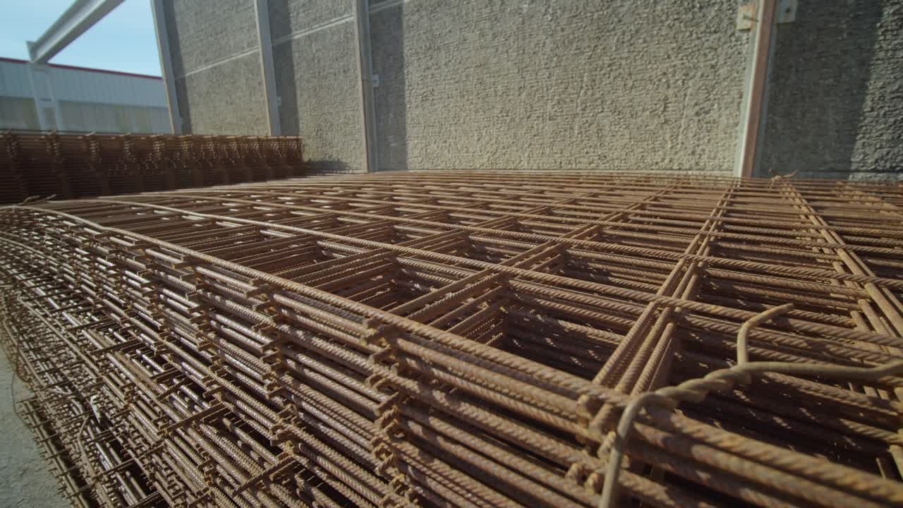 Close-up view about stacked metal rebars aka iron mesh for construction.