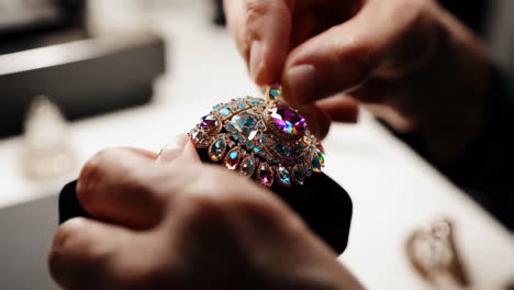 jeweler crafting a detailed brooch