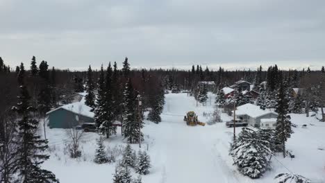 drone video captures the power and a snow plow in action as it clears snow in the winter wonderland of alaska