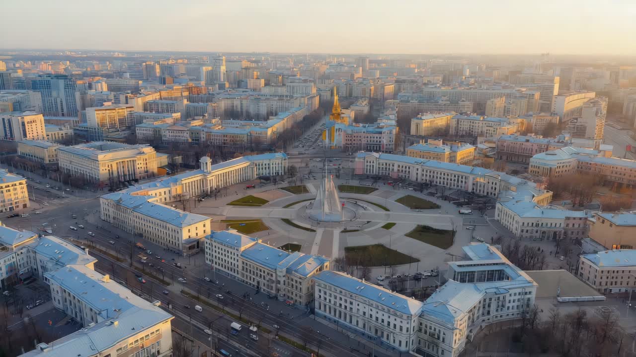 Aerial View of a European City Square with Monument at Sunset
