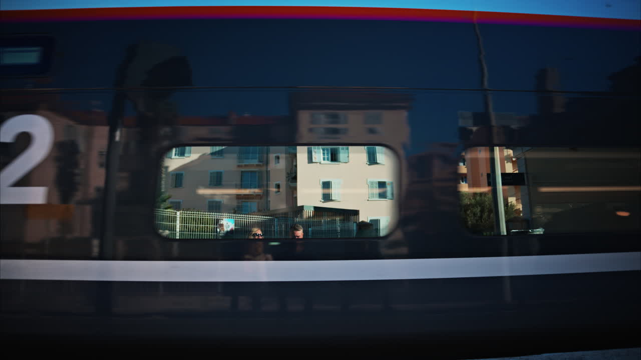 Close up of a colourful train moving on the rails near a station in France