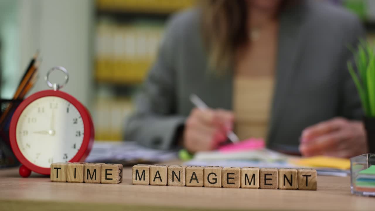 Time Management Word Blocks with Alarm Clock and Person Working
