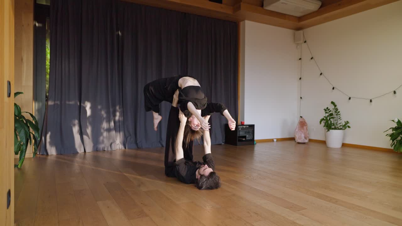 AcroYoga Couple Balancing in Studio