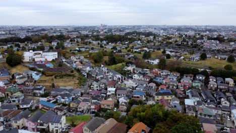 A-dense-colorful-residential-area-during-daylight,-aerial-view