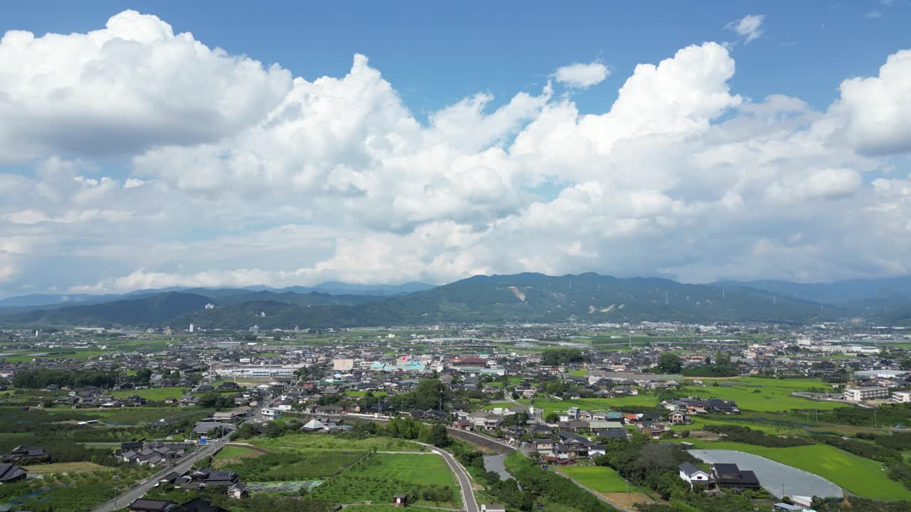 Cinematic drone reveal from viewpoint over typical Japanese countryside landscape