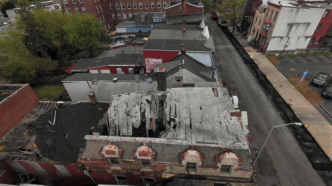 Aerial View of Severely Damaged and Crumbling Rooftops in an Urban Landscape