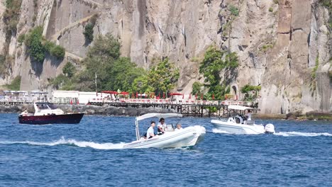 two boats passing near a scenic pier