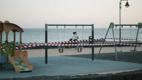 covid-19 restrictions playground being enclosed with warning tape