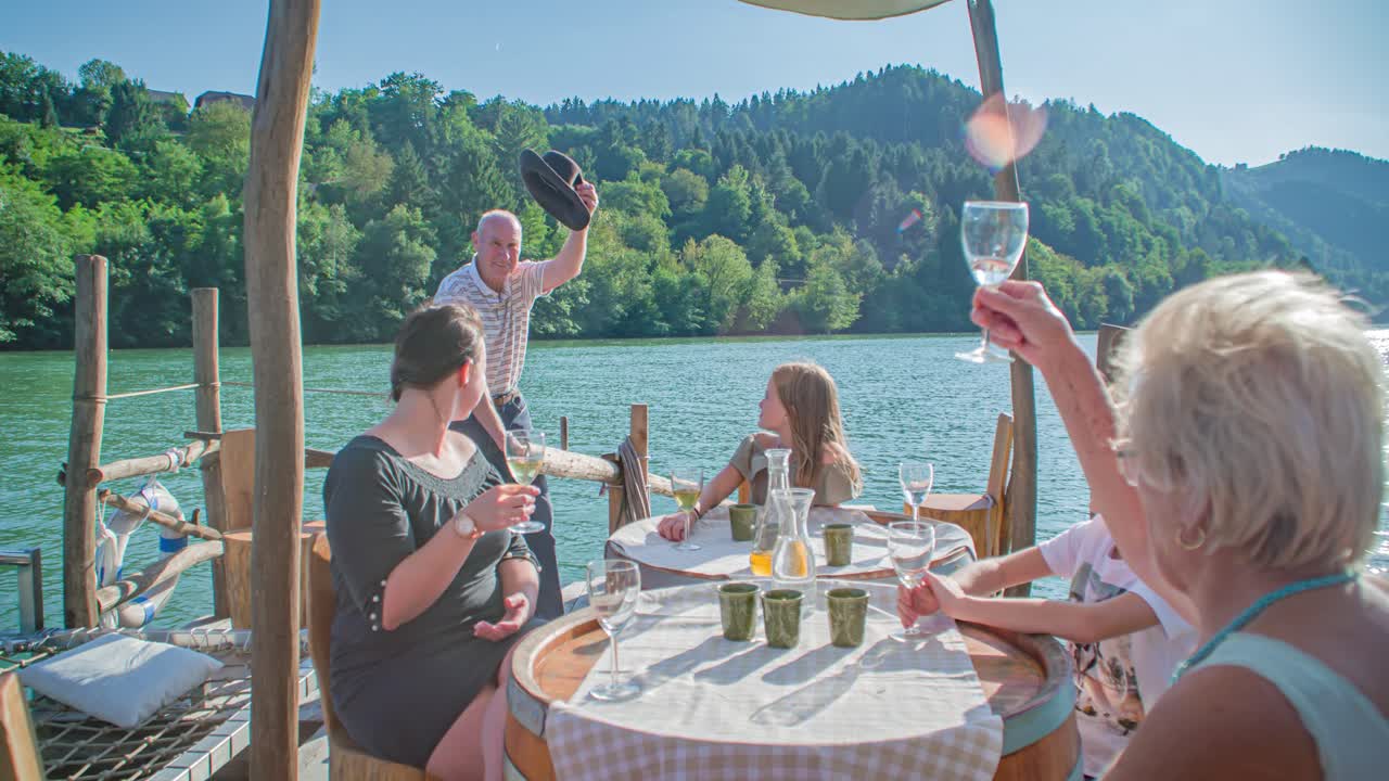 Happy multigenerational family having a drink on a log raft ride, river Drava
