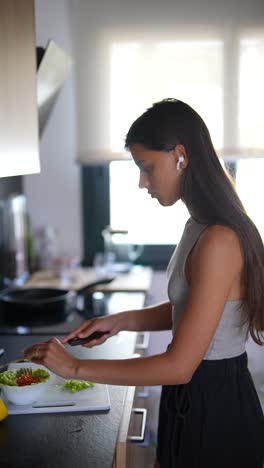 teenager preparing a salad in the kitchen