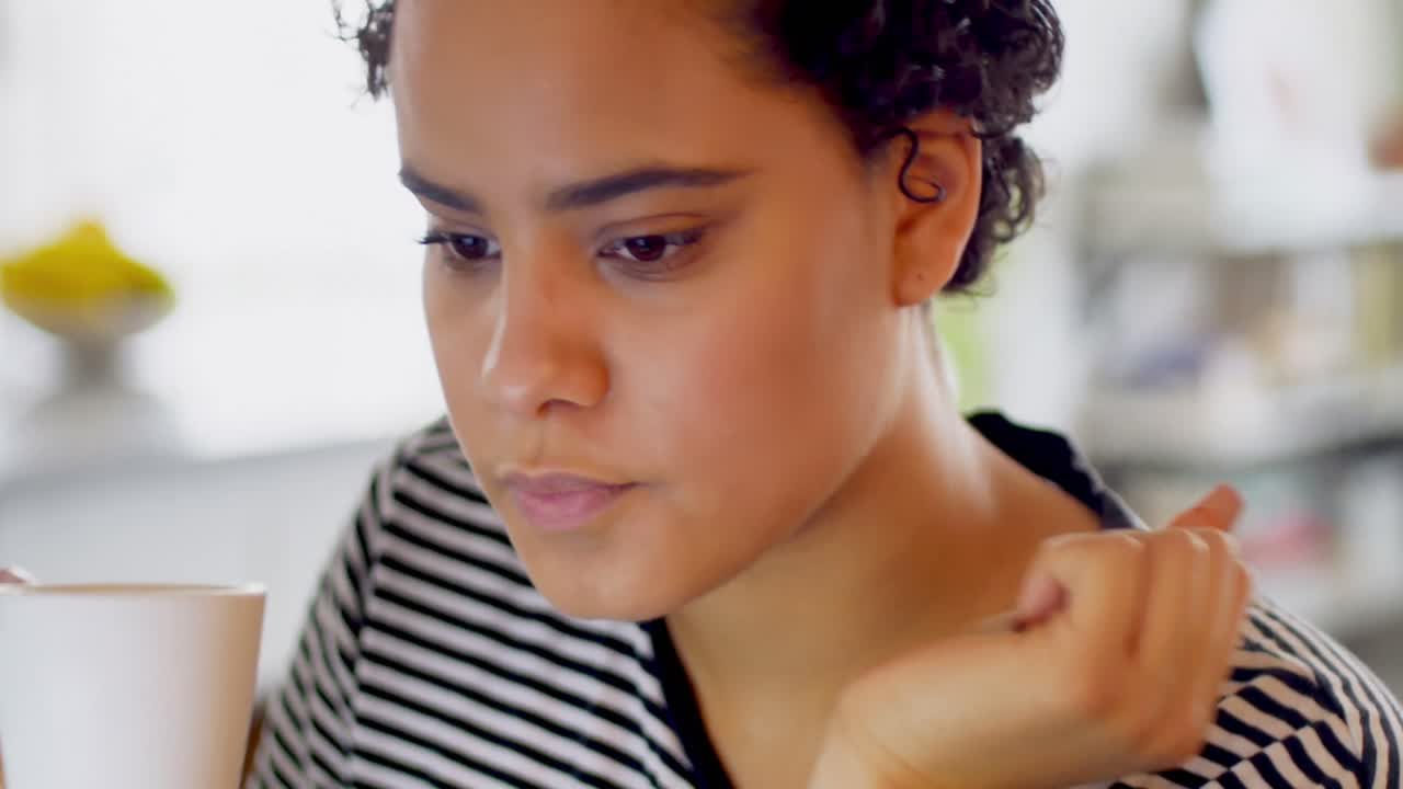 Thoughtful woman having cup of coffee 4k